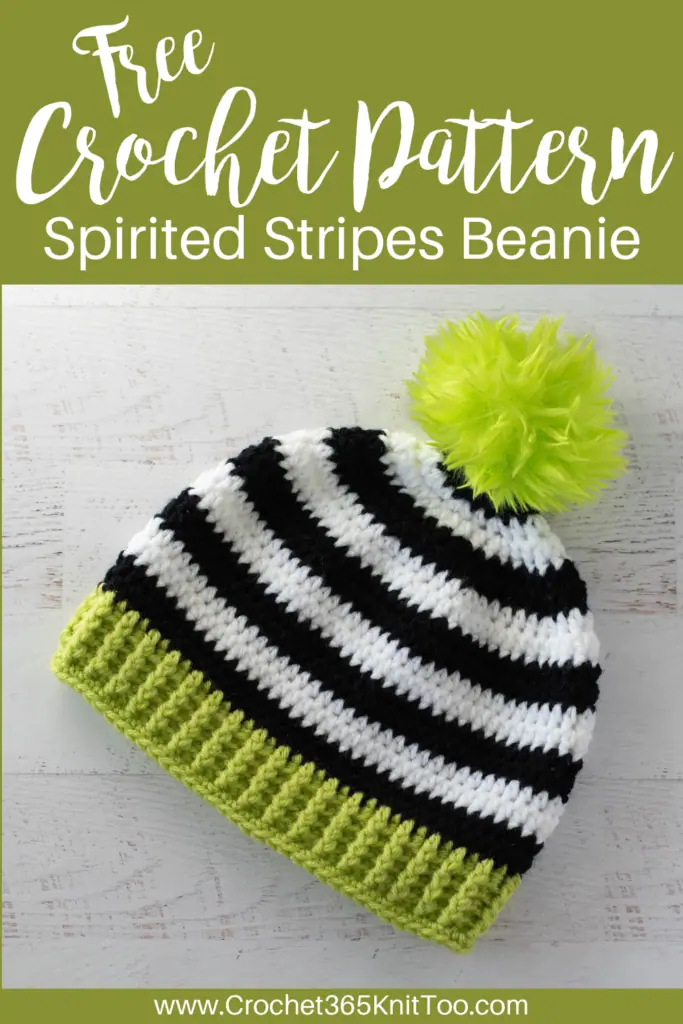 image of Black and white crocheted beanie with bright green brim and pom pom