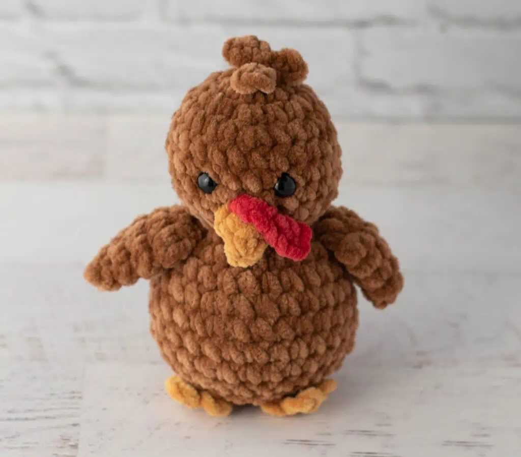Brown crochet turkey with gold beak and feet