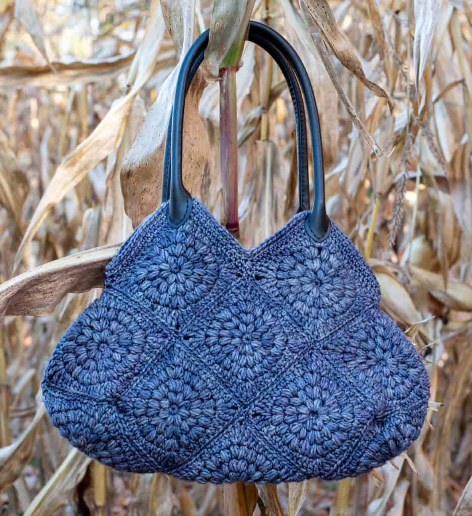 Blue crochet bag hanging on a corn stalk