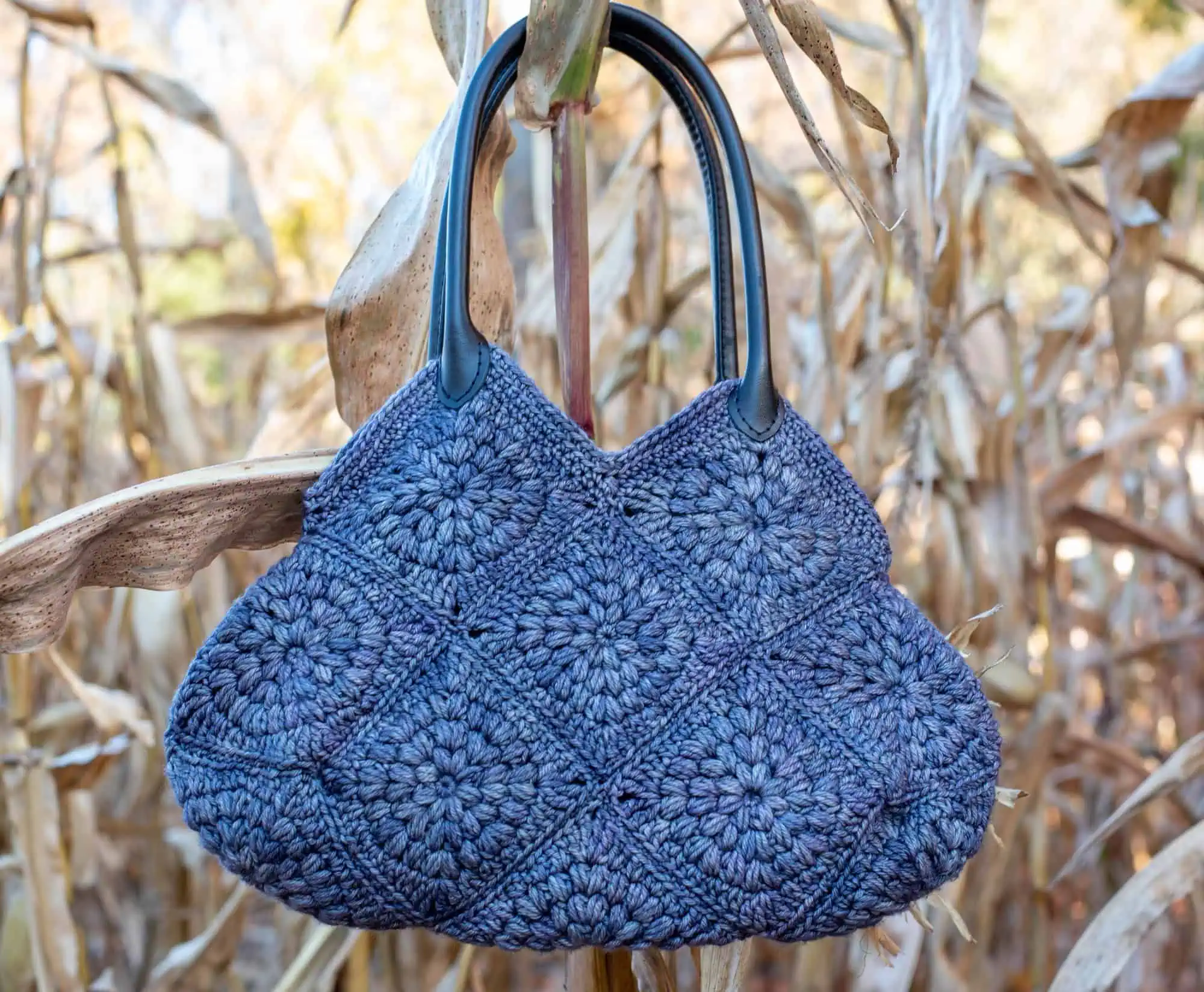 Blue crochet bag hanging on a corn stalk
