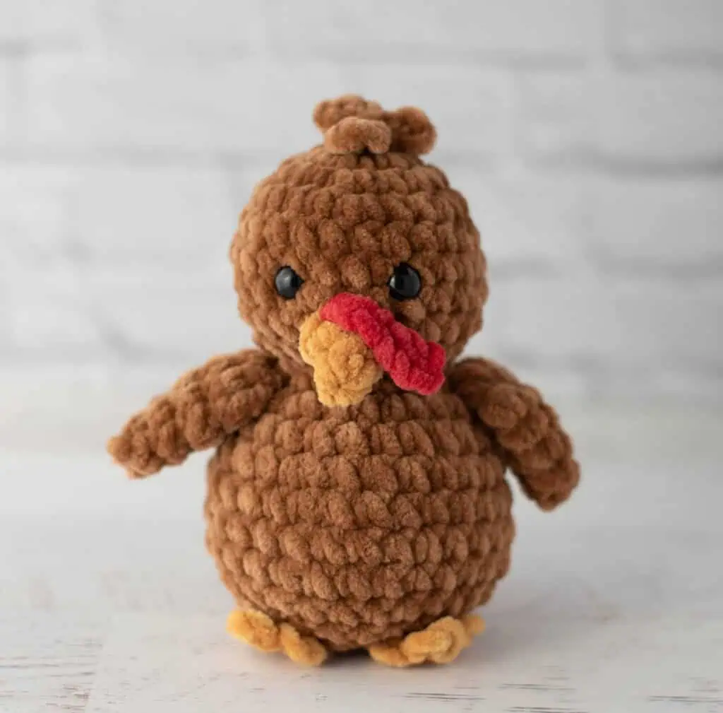 Brown crochet turkey with gold beak and feet