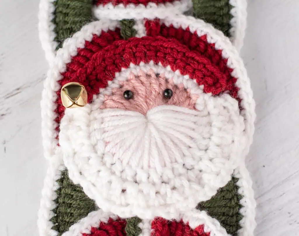 Crochet santa applique on red and green crochet wallhanging