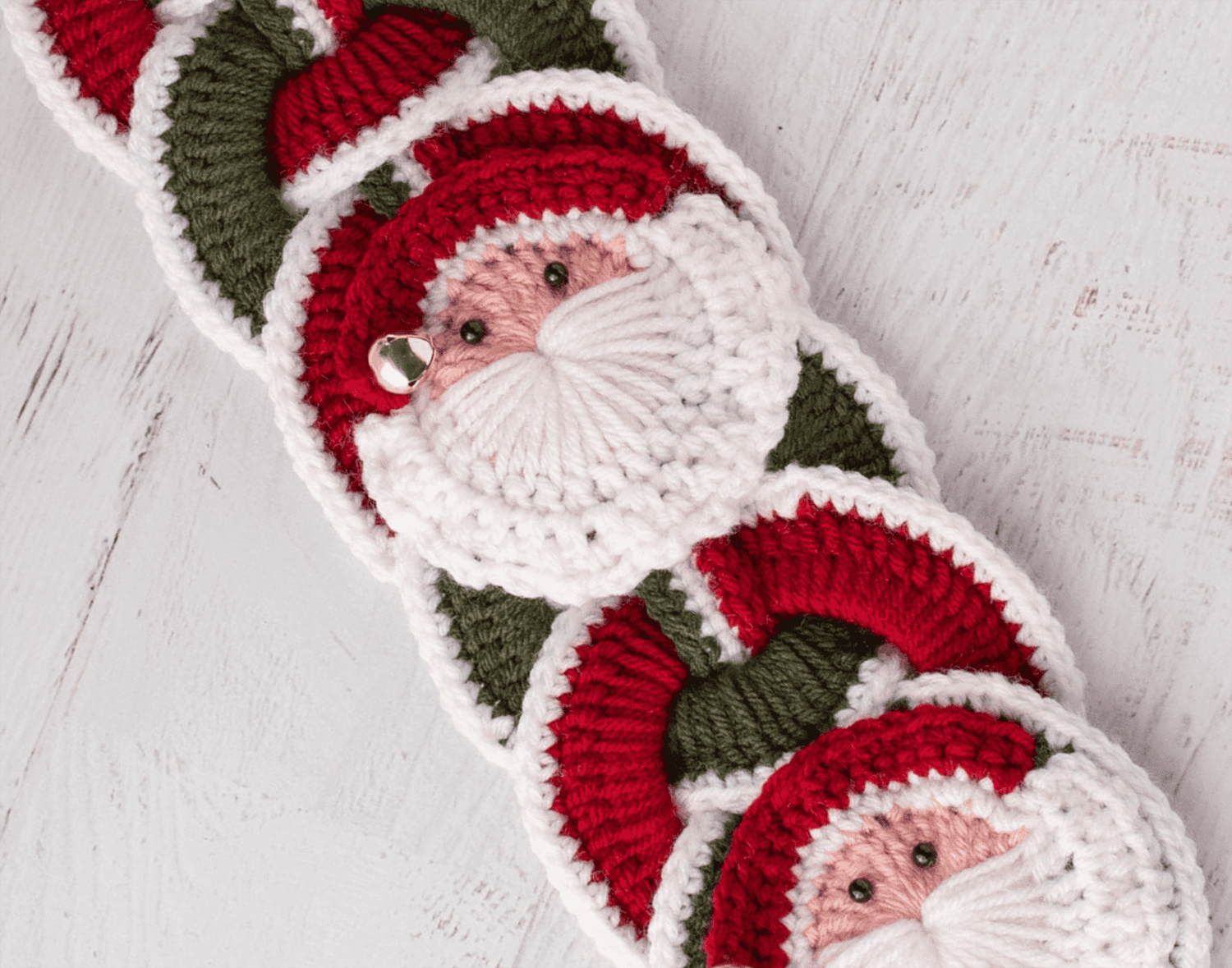 Crochet santa applique on red and green crochet wallhanging