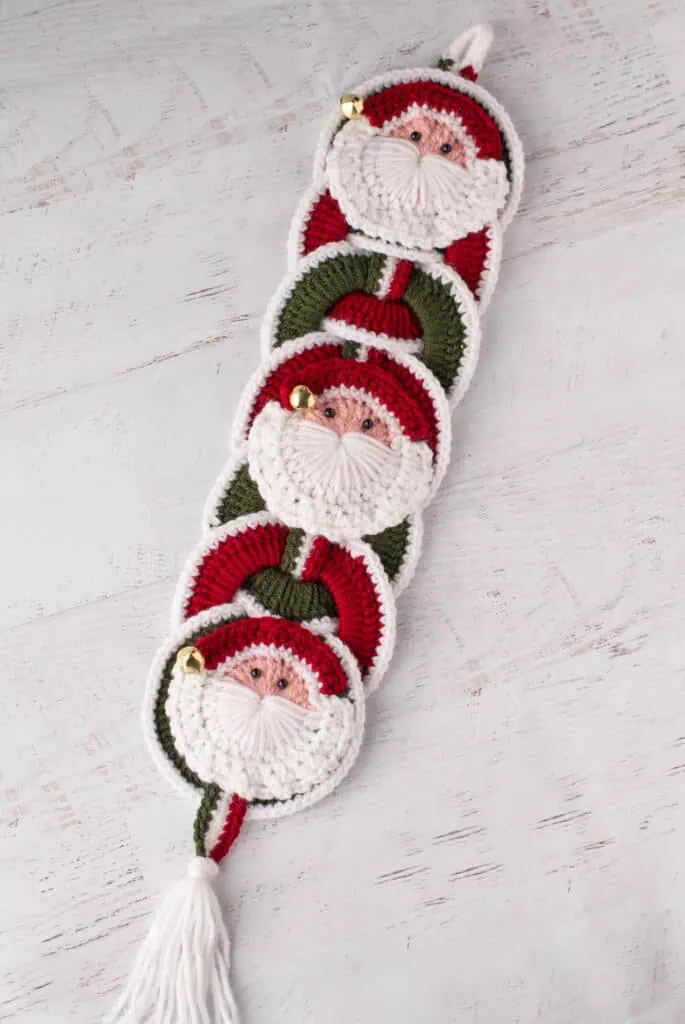 Crochet santa applique on red and green crochet wallhanging