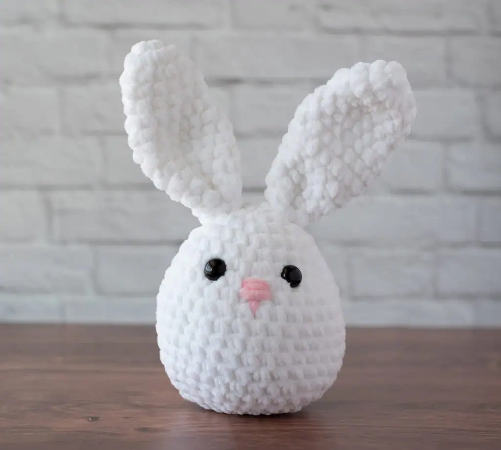 White plush crochet bunny with pink nose