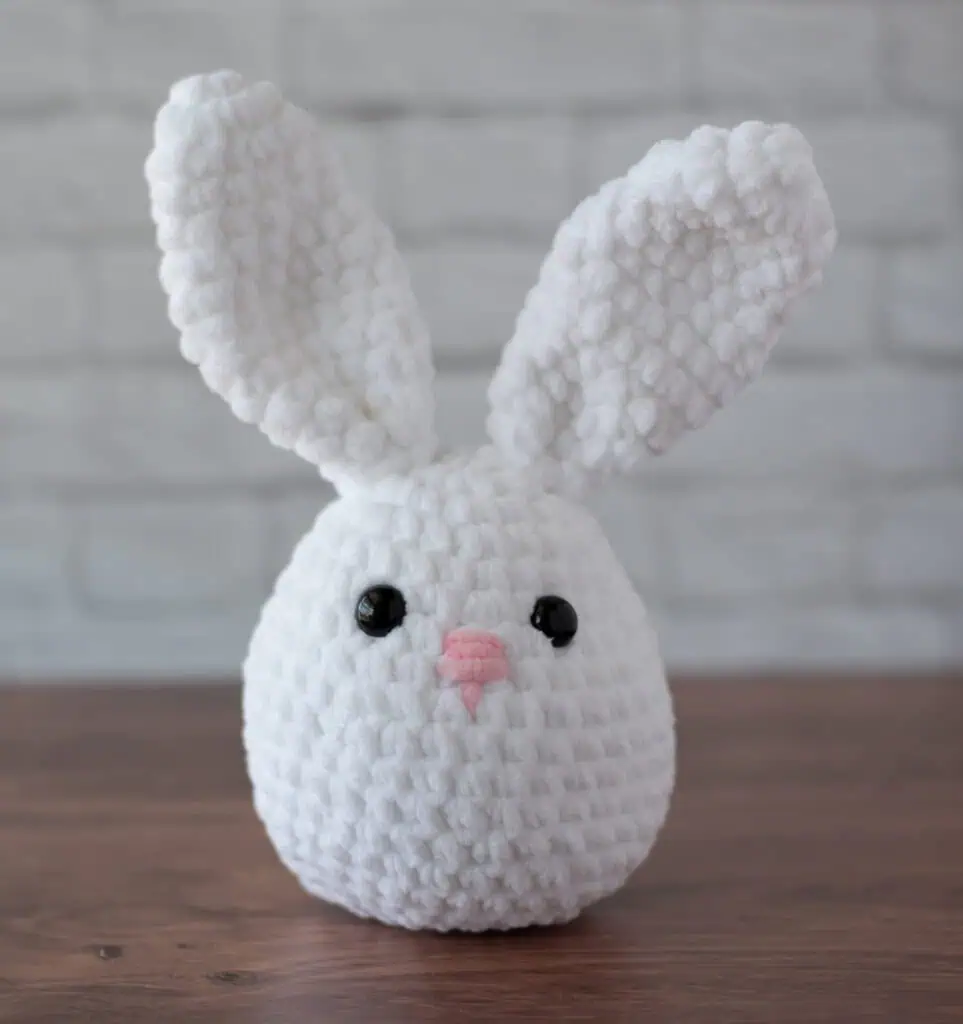 White plush crochet bunny with pink nose
