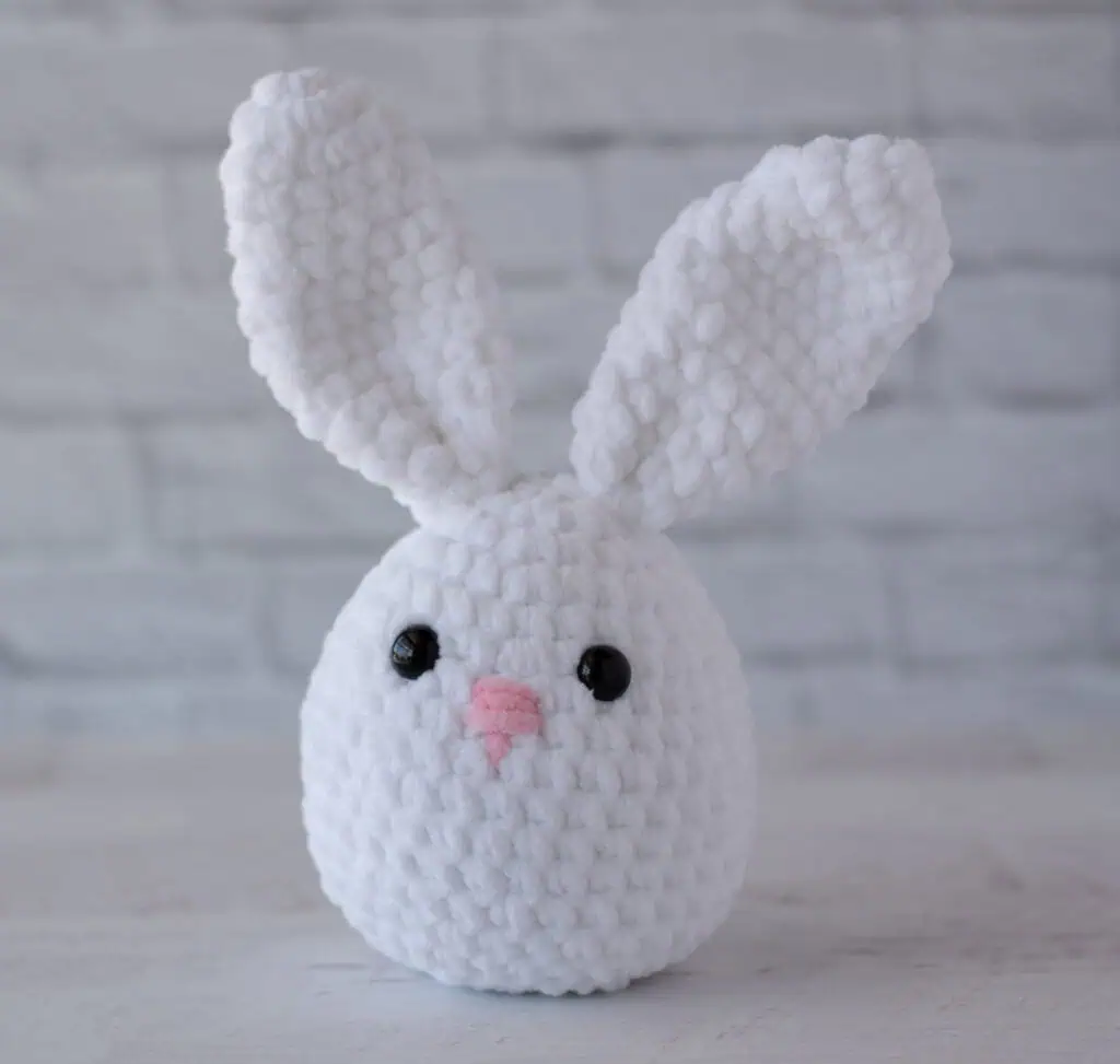 White plush crochet bunny with pink nose