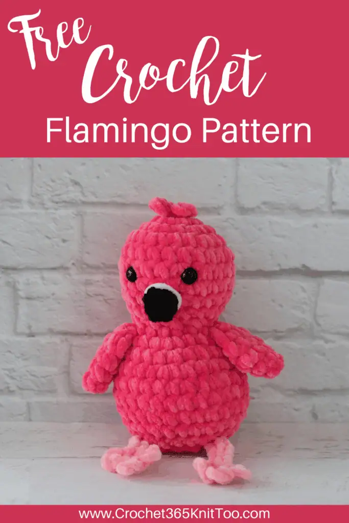 Image of crochet flamingo in front of white brick wall