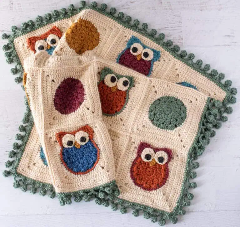 Colorful crochet owl blanket, handmade with vibrant yarns, perfect for cozy home decor and gift-giving.