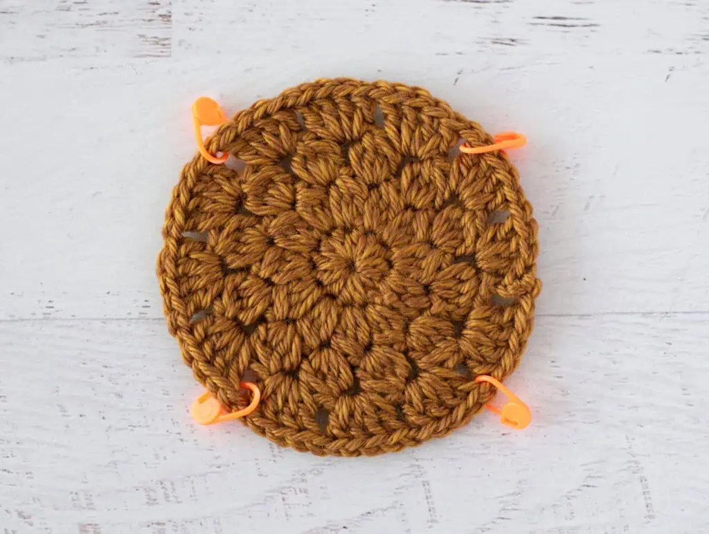 gold crochet circle with stitch markers