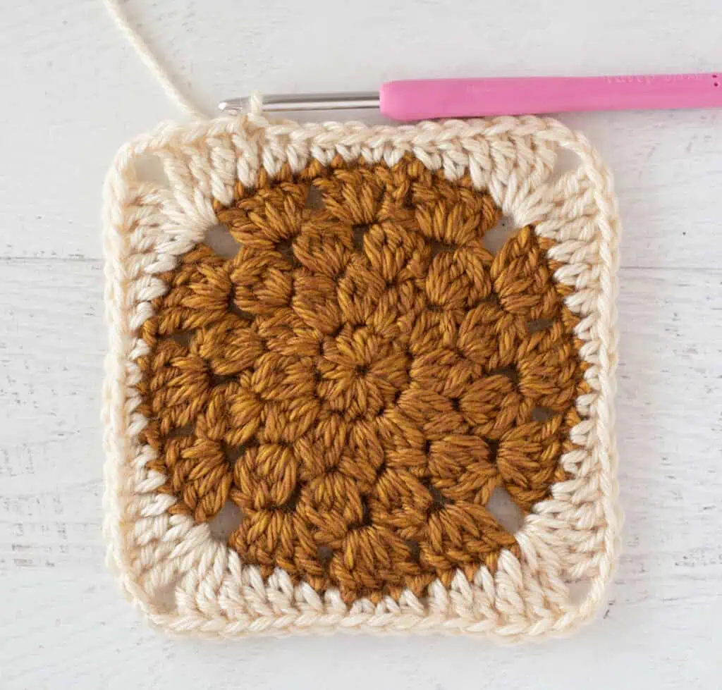 gold and cream crochet afghan square with crochet hook