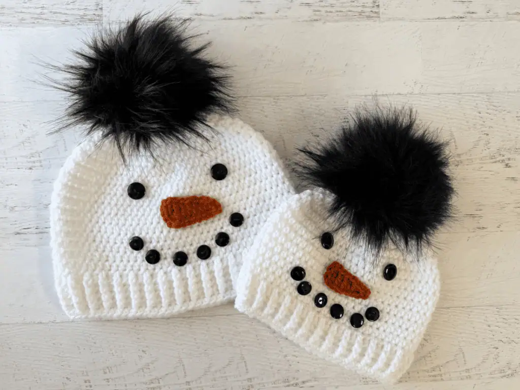 Child and adult sized white and black snowman hats.