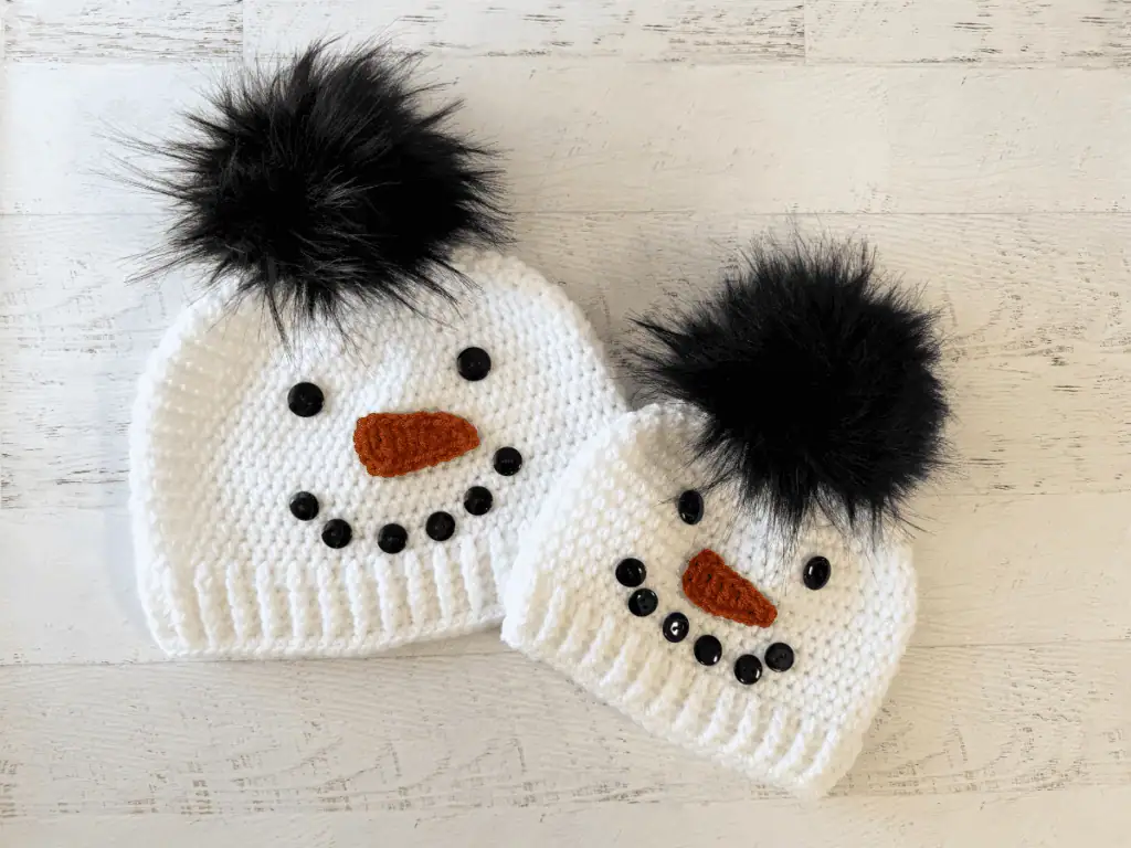Child and adult sized white and black snowman hats.