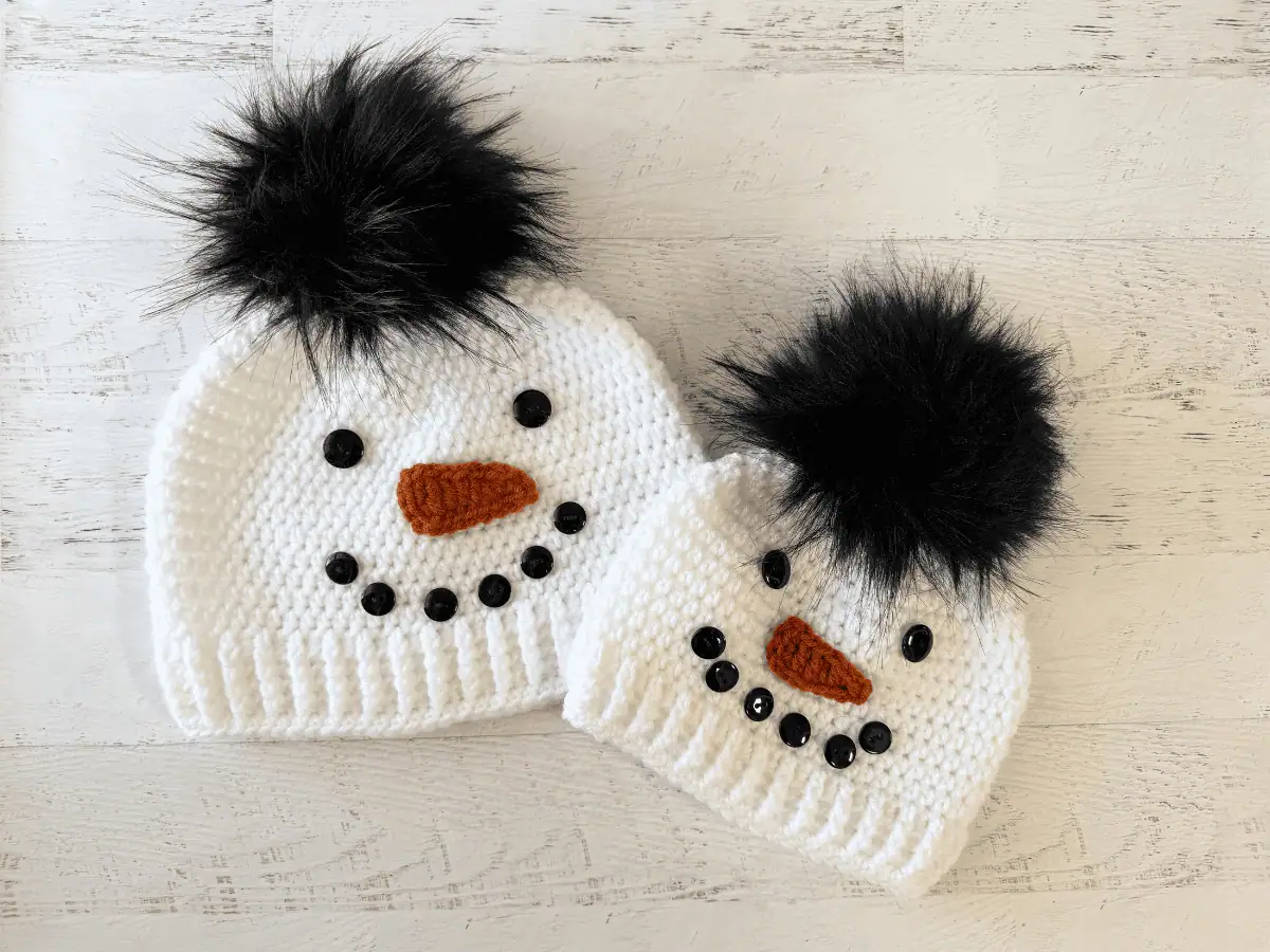 Child and adult sized white and black snowman hats.