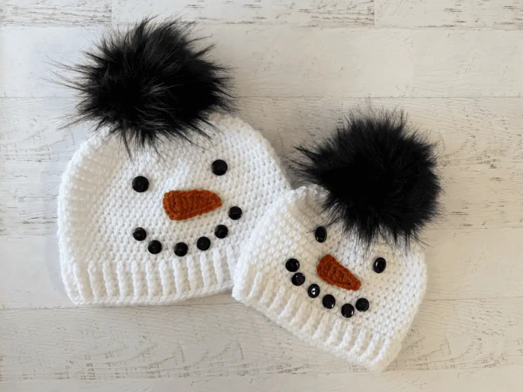 Child and adult sized white and black snowman hats.