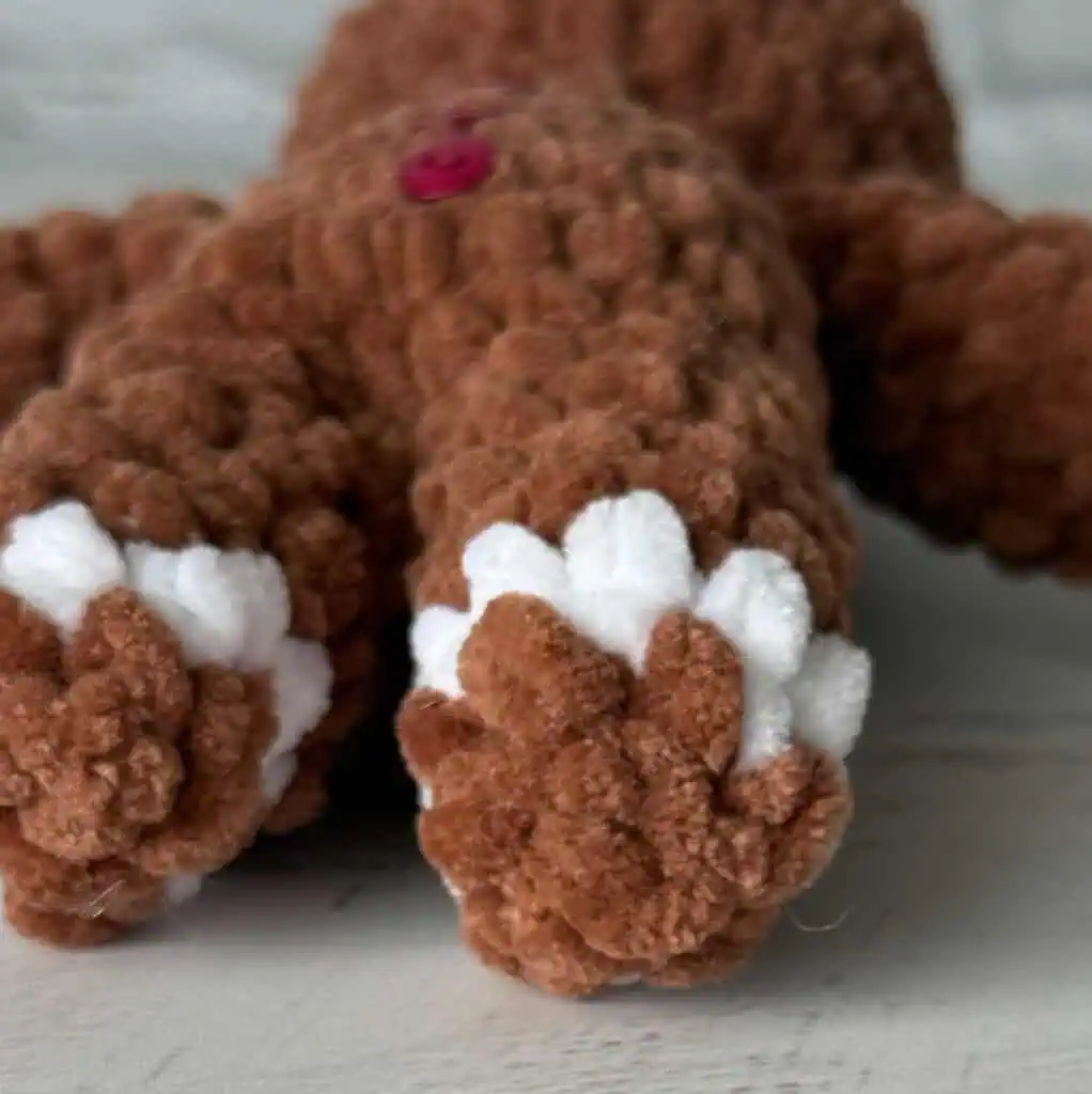 Crocheted plush gingerbread showing feet