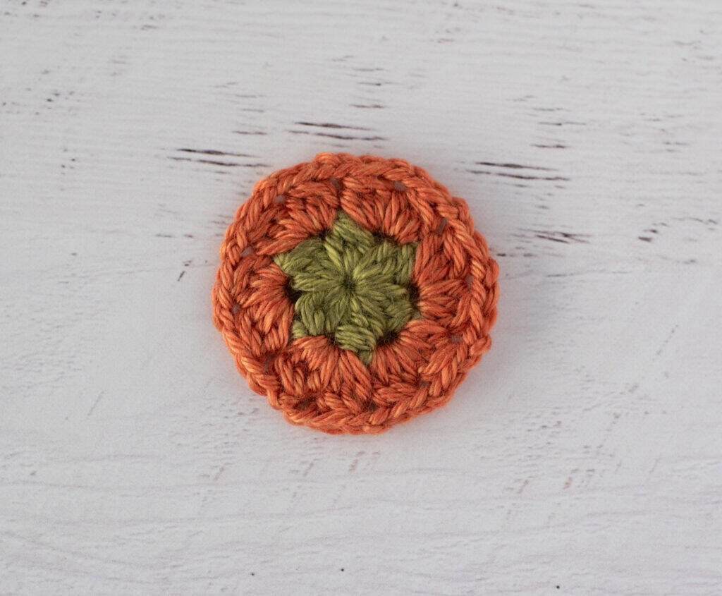 crochet motif in green and orange yarn