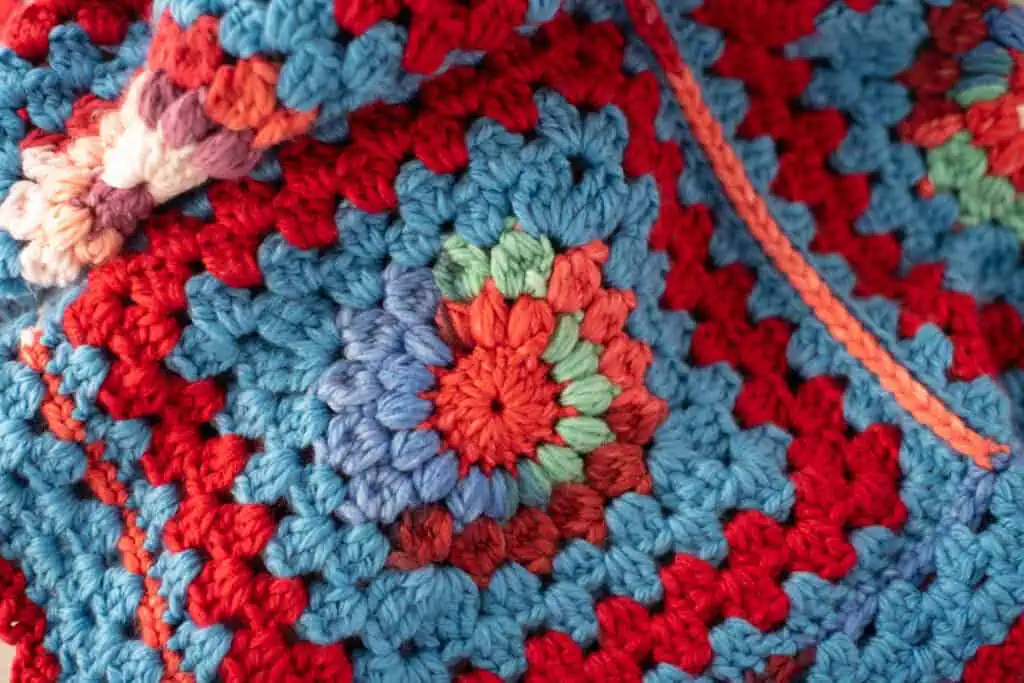 Close up of a colorful crochet granny square afghan