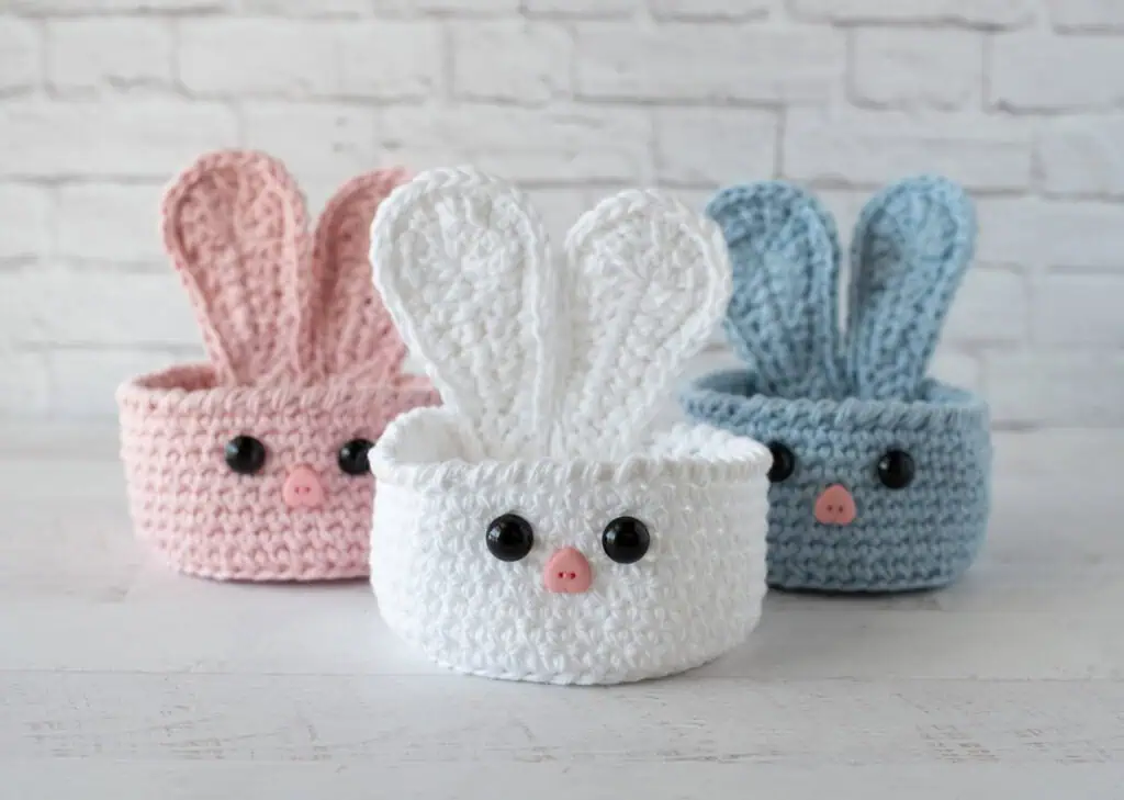 bunny baskets out of pink, white and blue yarn
