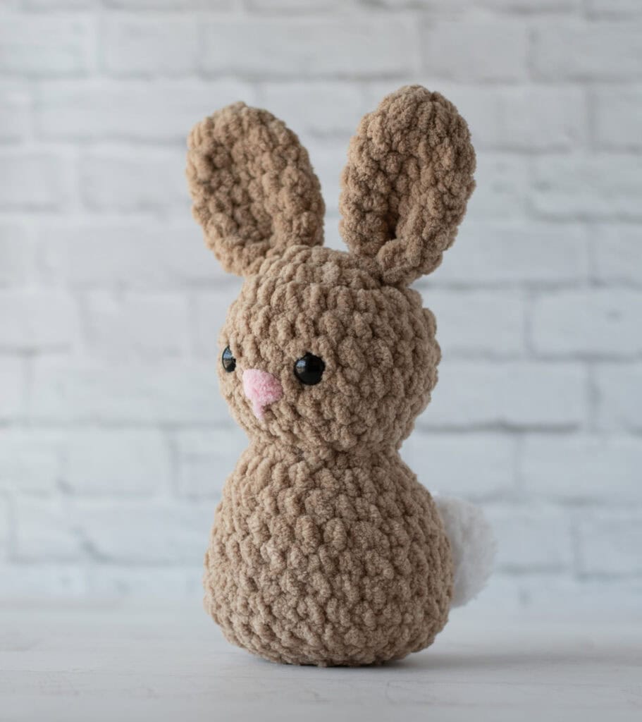 Brown Crochet Bunny with pink nose, black eyes and white tail
