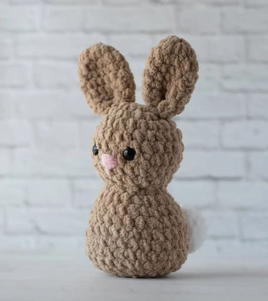 Brown Crochet Bunny with pink nose, black eyes and white tail