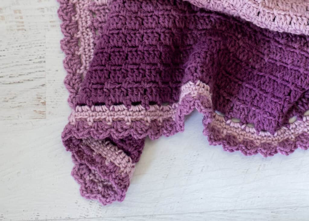 Scallop border of crochet afghan in purple yarn