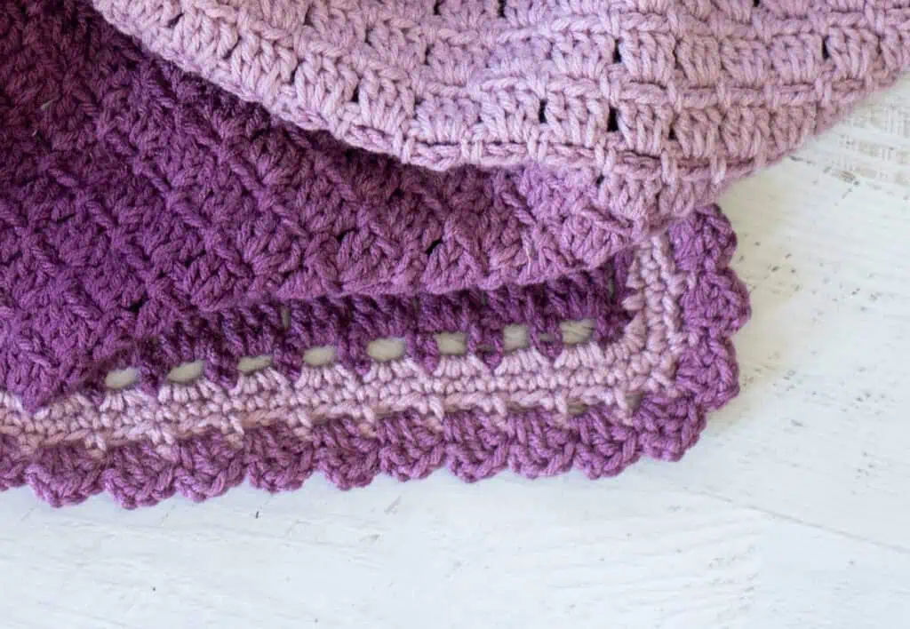 Corner of crochet baby afghan in purple variegated yarn