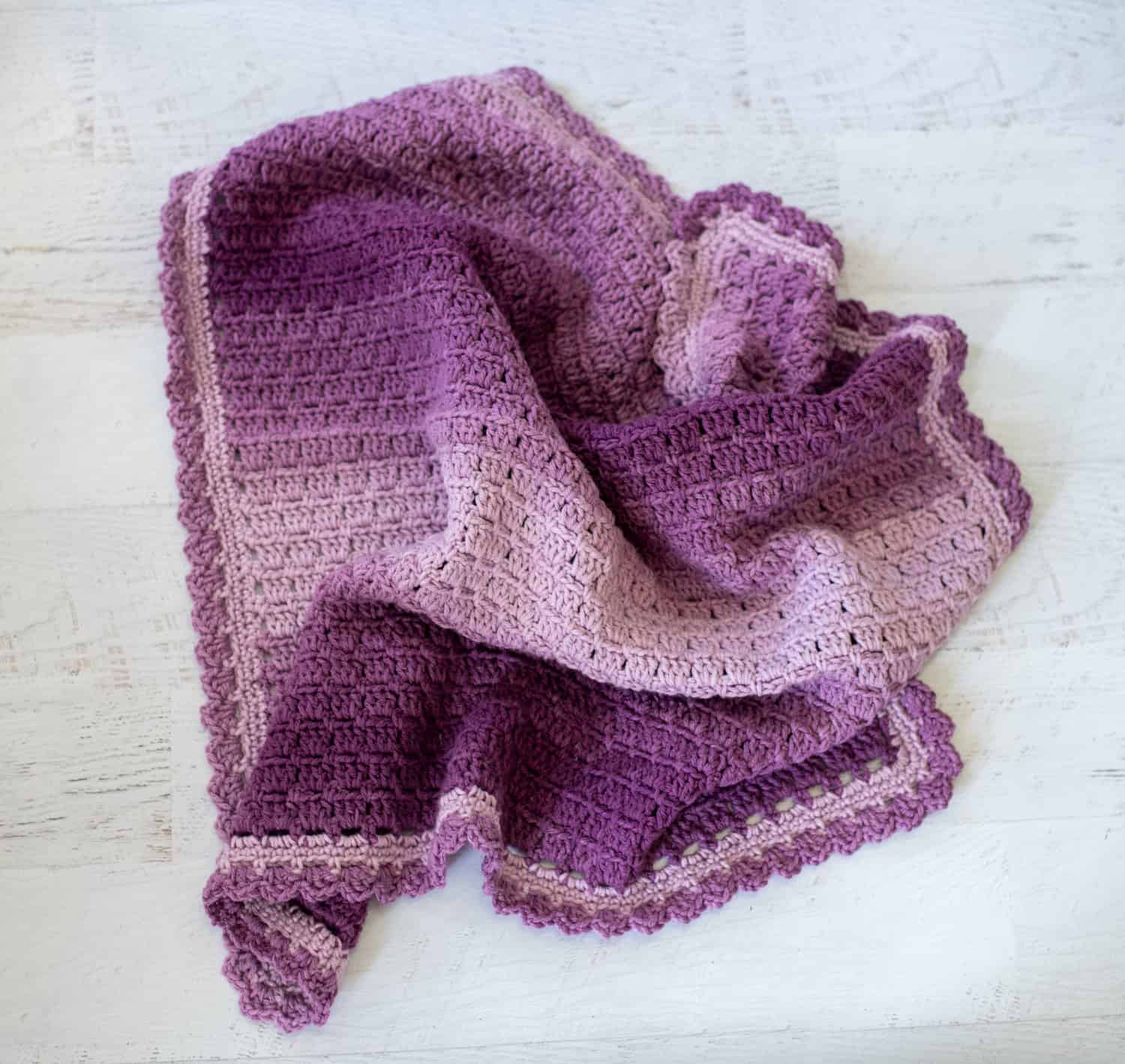Crochet purple baby afghan scrunched up