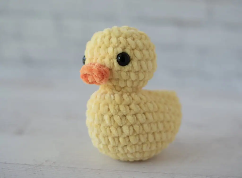 Completed crochet rubber duck facing left