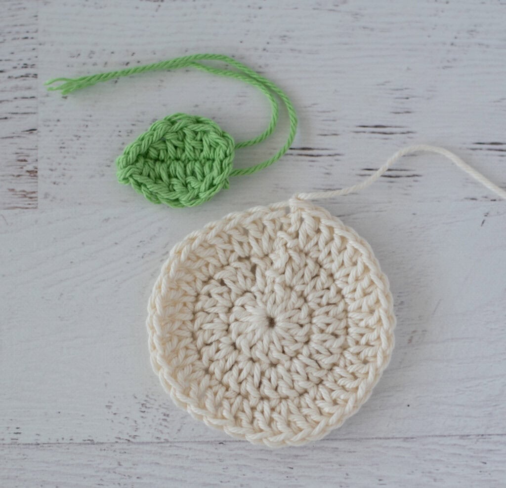 cream crochet circle and green crochet leaf