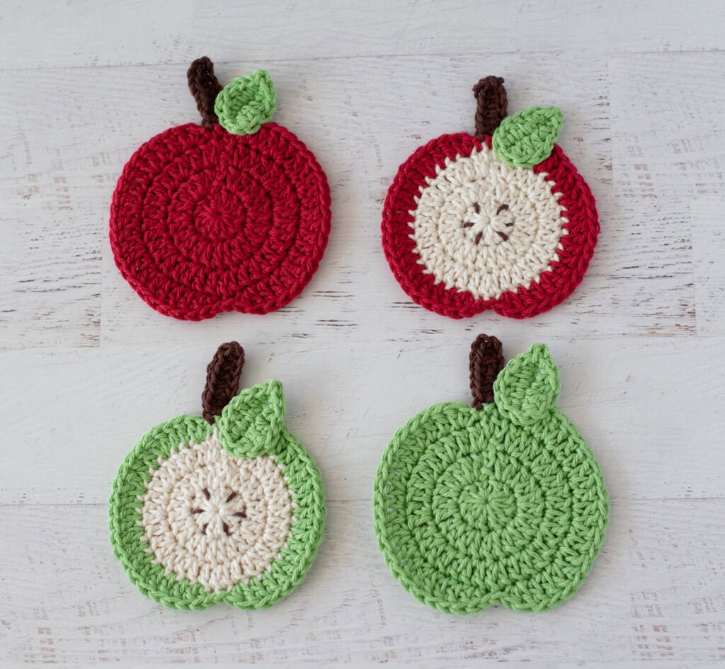 4 crochet apple coasters in red, green and cream yarn